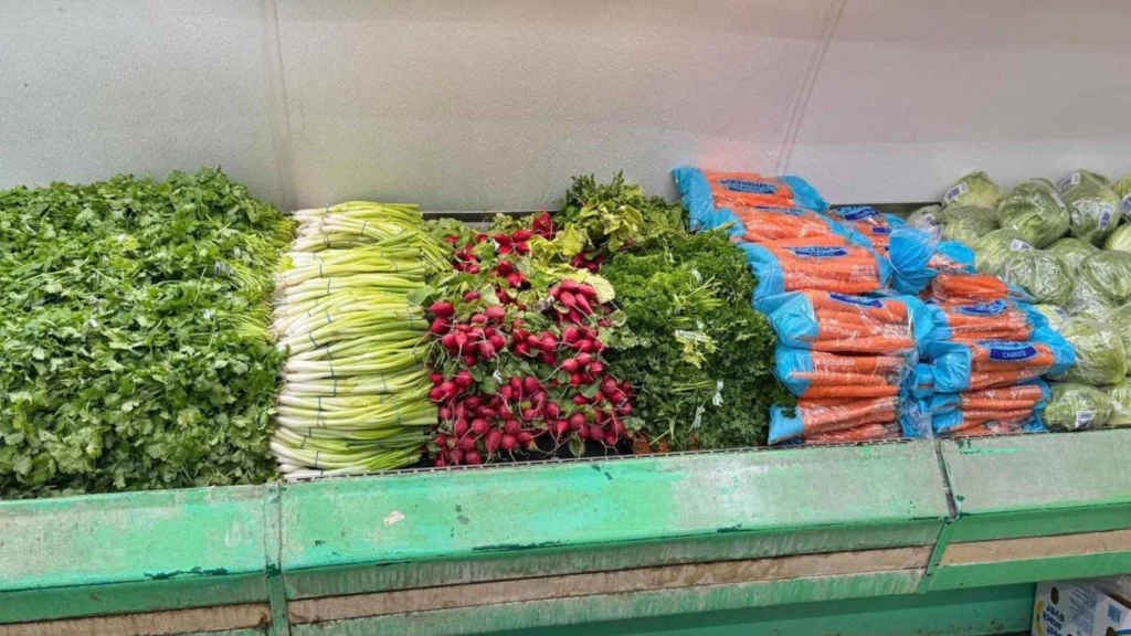 Leafy greens, celery, radishes and carrots on the produce stand at Butcher & Farmer Market in Buckeye, AZ.