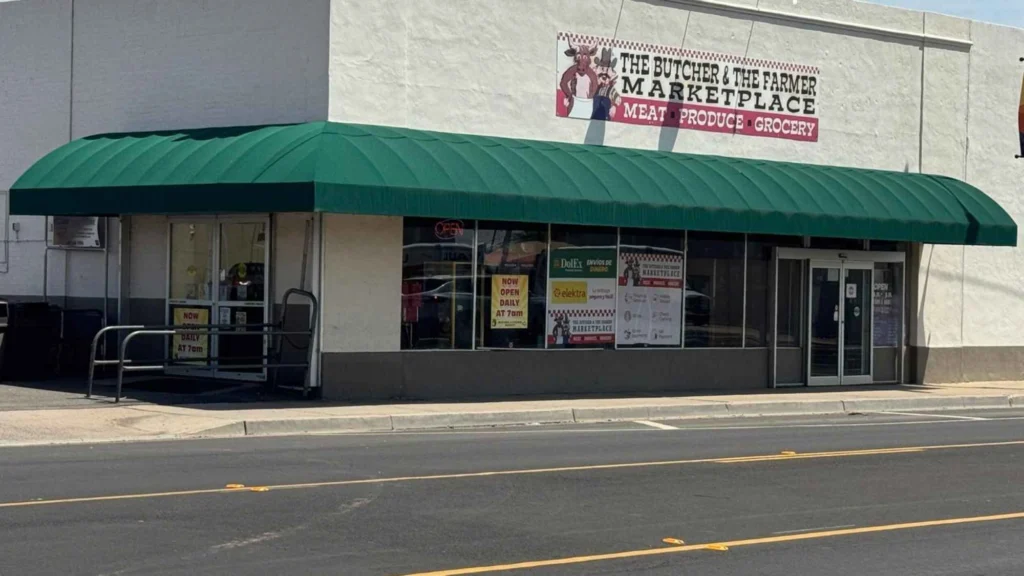 Butcher & Farmer Market entrance under the green awning in Buckeye, AZ.
