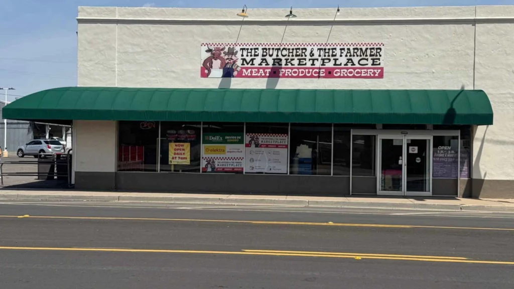 Butcher & Farmer Market storefront with green awning and entrance in Buckeye, AZ.