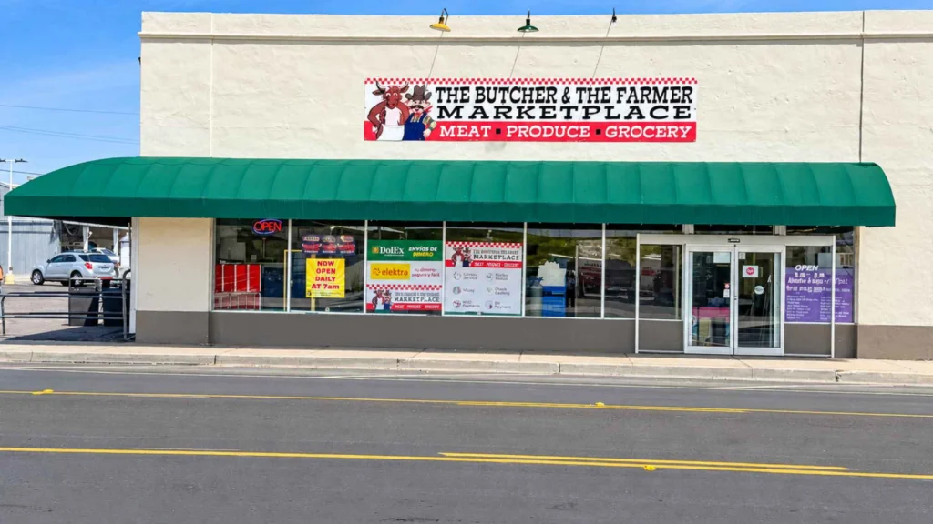 Butcher & Farmer Market storefront with green awning, sign and front entrance in Buckeye, AZ.