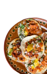 Plate of Mexican street tacos al pastor with pineapple, onion and cilantro on corn tortillas, made with specialty meats from Butcher & Farmer Market in Buckeye, AZ