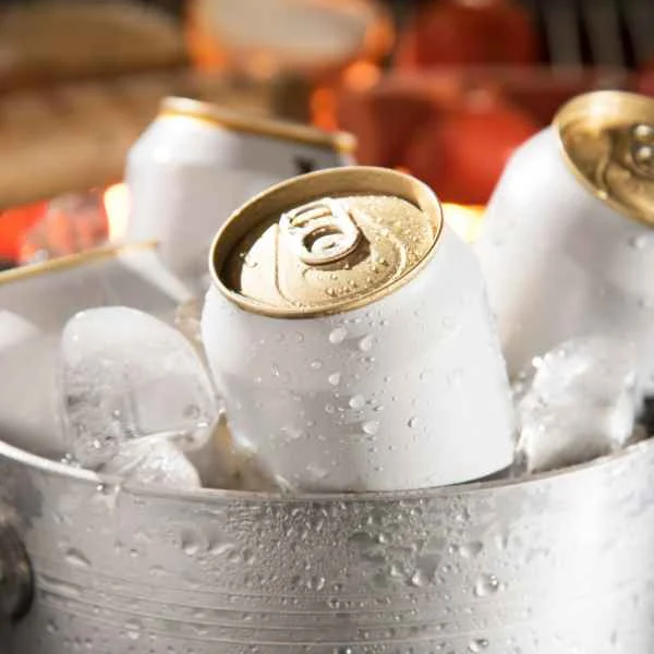 Chilled beer cans sitting in a bucket of ice