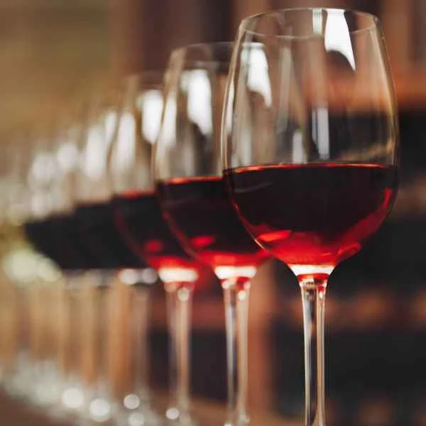 Row of glasses filled with red wine