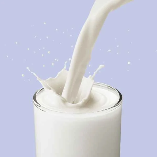 Fresh milk pouring into a glass
