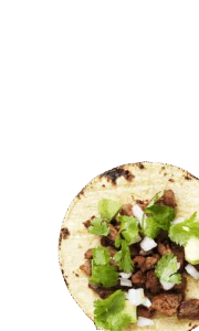 Street taco topped with grilled meat, chopped onion and cilantro on a corn tortilla