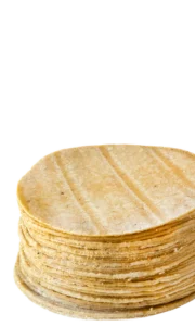 Stack of fresh corn tortillas made in-house at Doña Lupe Tortillería inside Del Sol IGA Mexican grocery stores