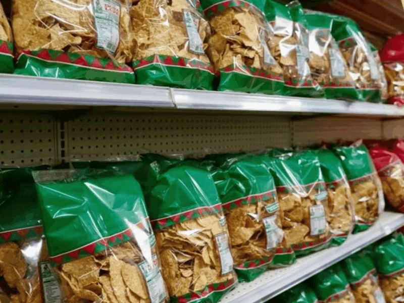 Shelves stocked with bags of Doña Lupe tortilla chips at Del Sol in San Luis, AZ