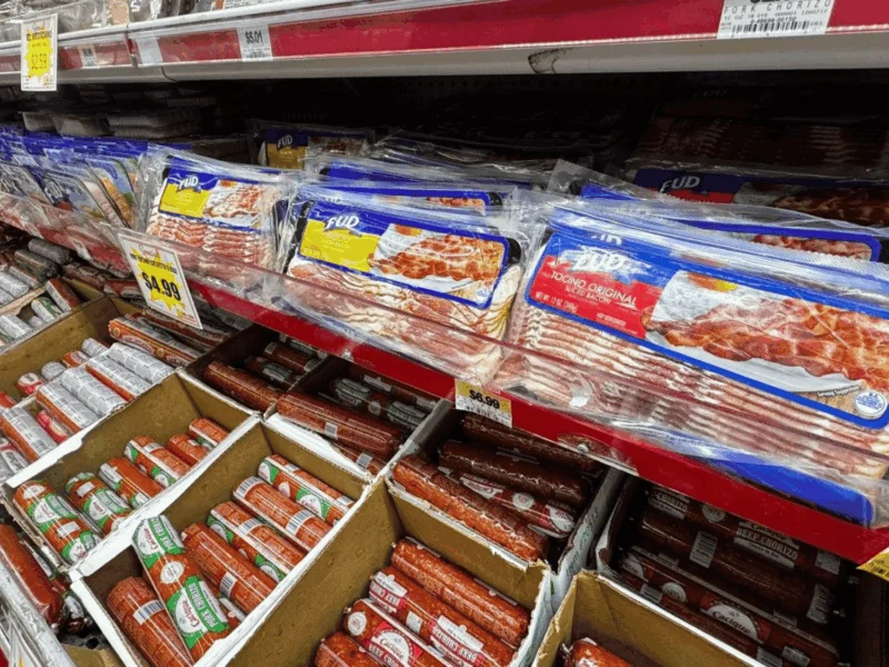 Refrigerated meat case stocked with packaged meats at Del Sol Market San Luis East in San Luis, AZ