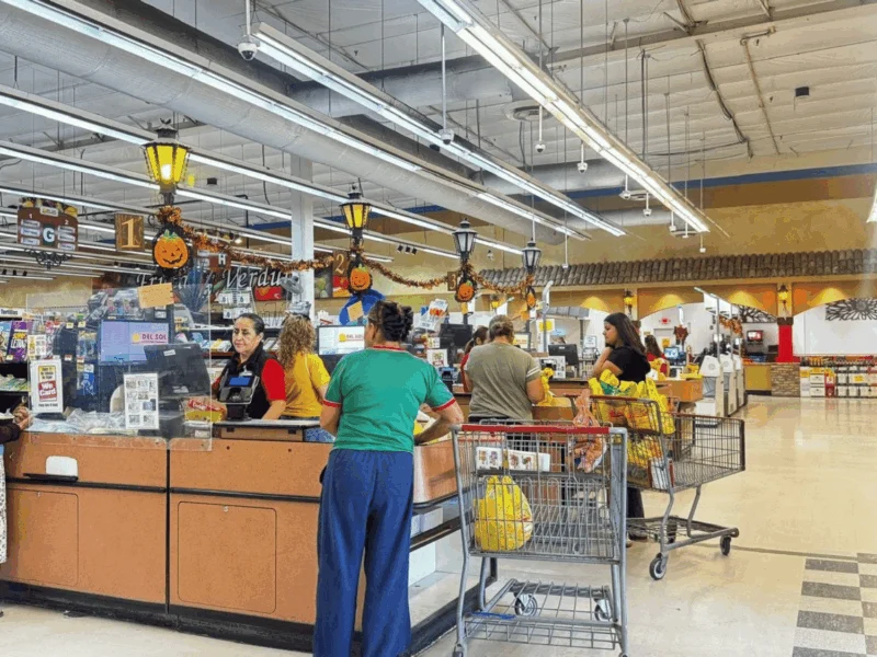 Customers at the checkout lanes at Del Sol Market San Luis East in San Luis, AZ