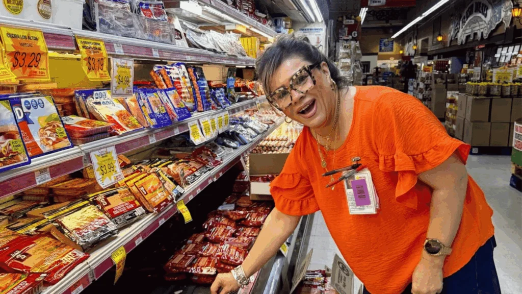 Smiling Del Sol team member stocking the meat case in San Luis, AZ