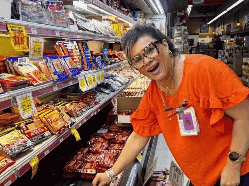 Smiling Del Sol team member stocking the meat case in San Luis, AZ