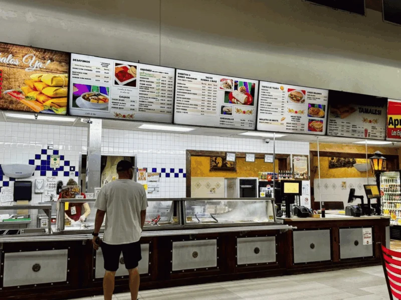 Restaurant counter with menu boards at Del Sol Market in San Luis, AZ