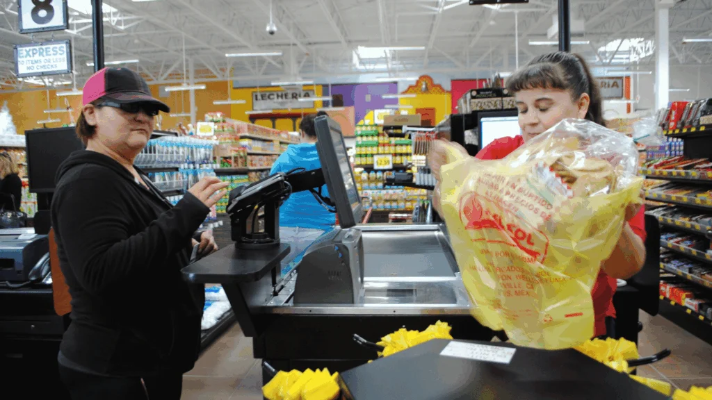 Cashier ringing up a customer at the checkout lane at Del Sol in Somerton, AZ