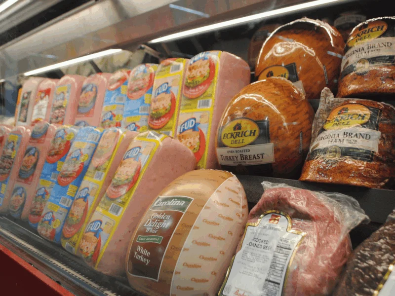 Deli case stocked with ham, turkey and lunch meats at Del Sol in Somerton, AZ