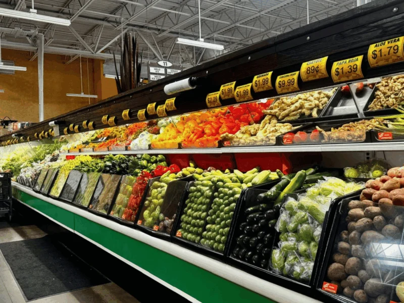 Long produce aisle stocked with fresh fruits and vegetables at Del Sol in Somerton, AZ
