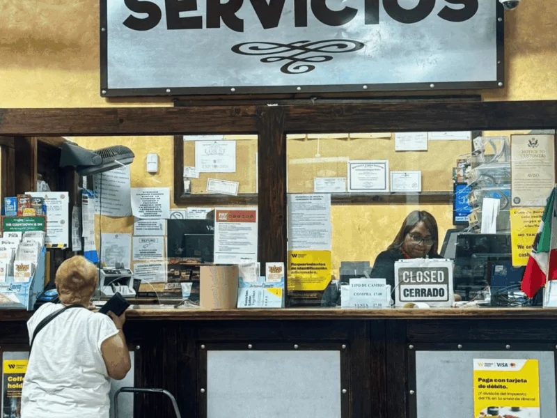 Customers at the Servicios counter for bill pay and money services at Del Sol in Somerton, AZ