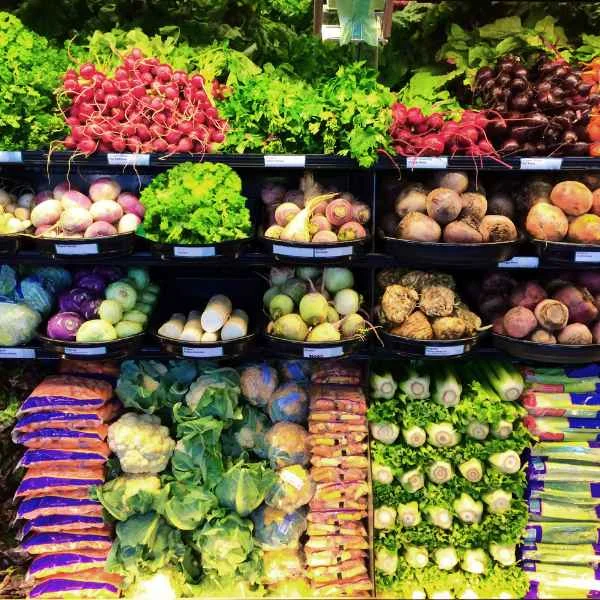 Produce department shelves stocked with fresh vegetables