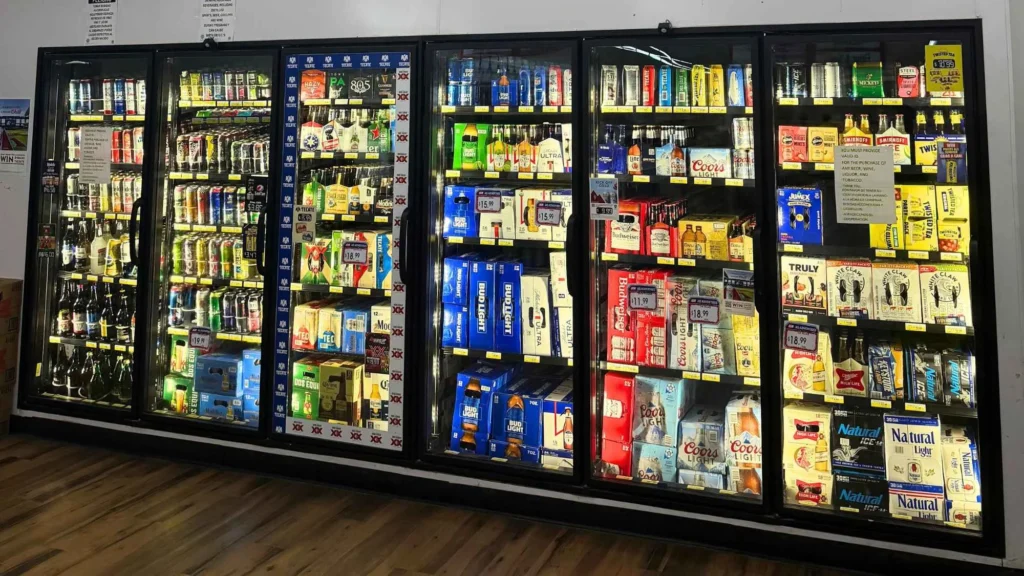 Glass-door coolers stocked with energy drinks, juices and cold beverages at Food Town IGA in Eloy