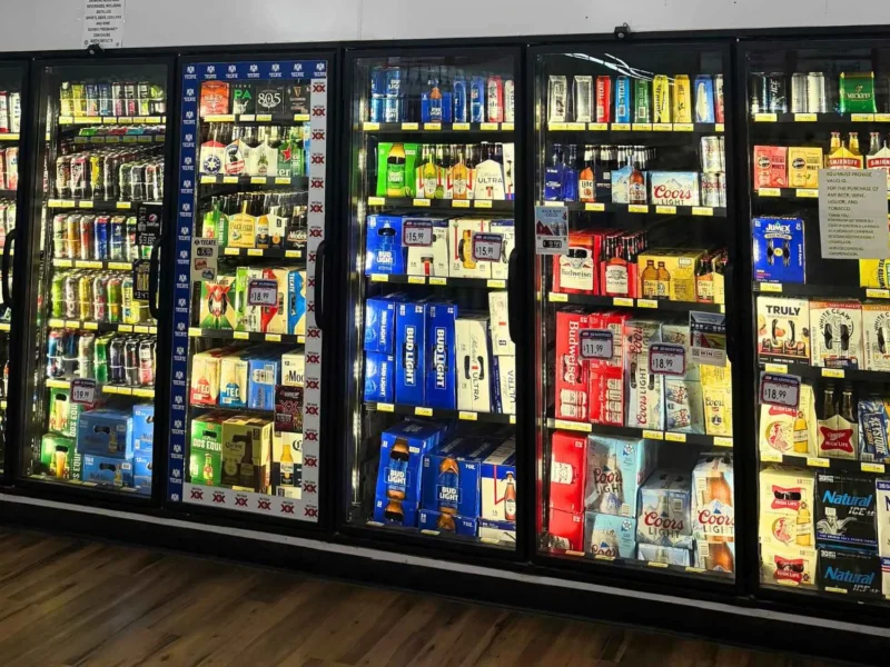 Glass-door coolers stocked with energy drinks, juices and cold beverages at Food Town IGA in Eloy