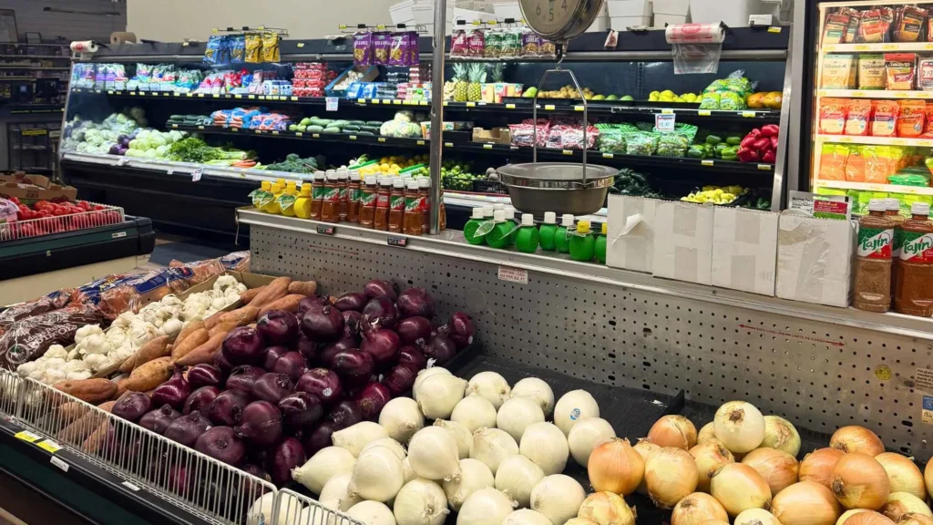 Produce department with red onions, white onions and fresh vegetables at Food Town IGA in Eloy