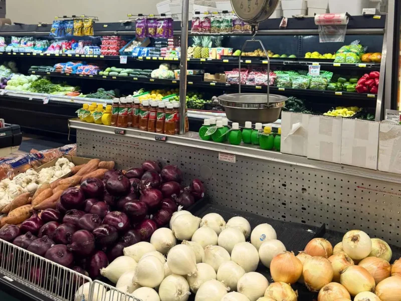 Produce department with red onions, white onions and fresh vegetables at Food Town IGA in Eloy