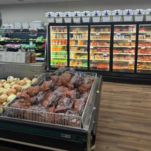 Bin of bagged potatoes in front of refrigerated cases at Food Town IGA in Eloy
