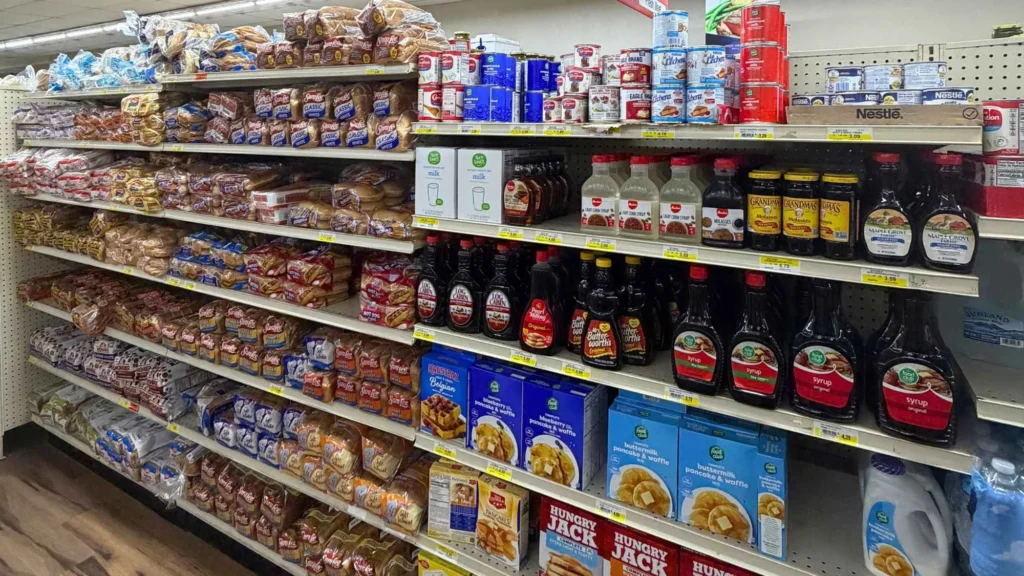 Grocery aisle stocked with syrup, pancake mix, bread and cereal at Food Town IGA in Eloy