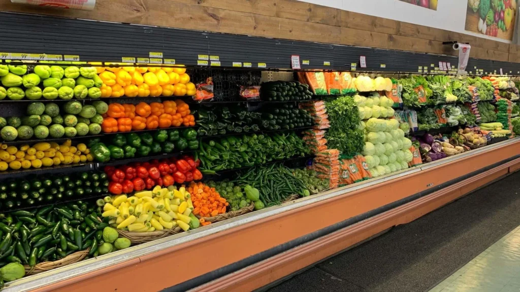 Colorful produce display of peppers, tomatoes, citrus and fresh vegetables