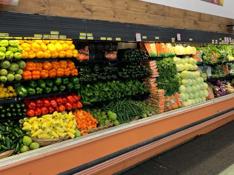 Colorful produce display of peppers, tomatoes, citrus and fresh vegetables