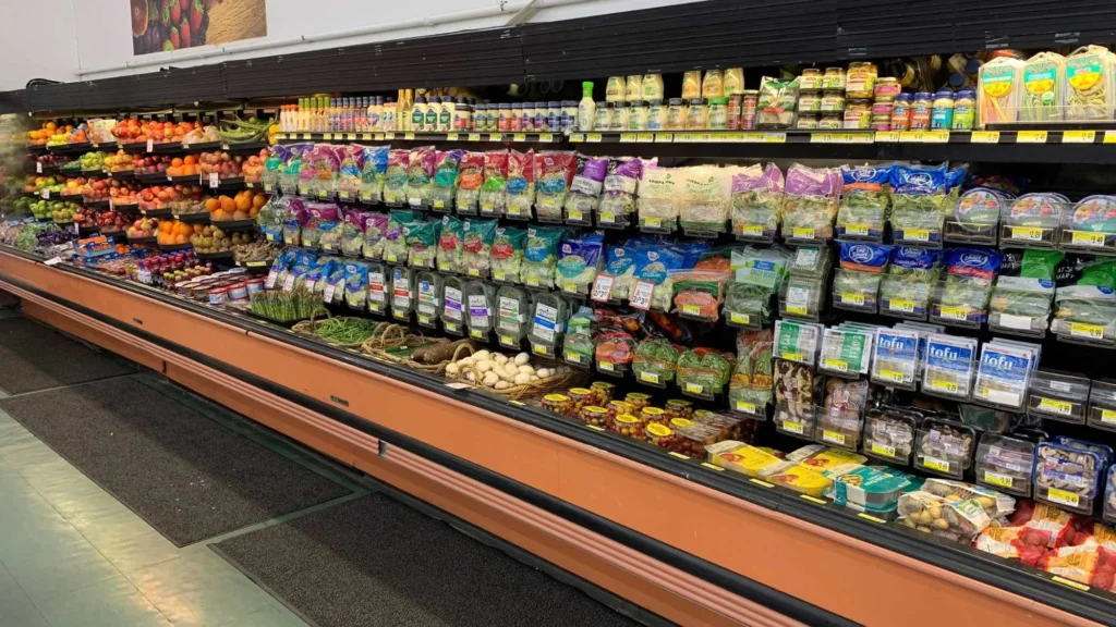 Wide view of the produce department with refrigerated produce cases