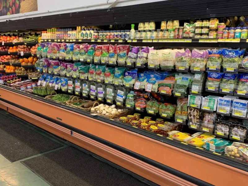 Wide view of the produce department with refrigerated produce cases