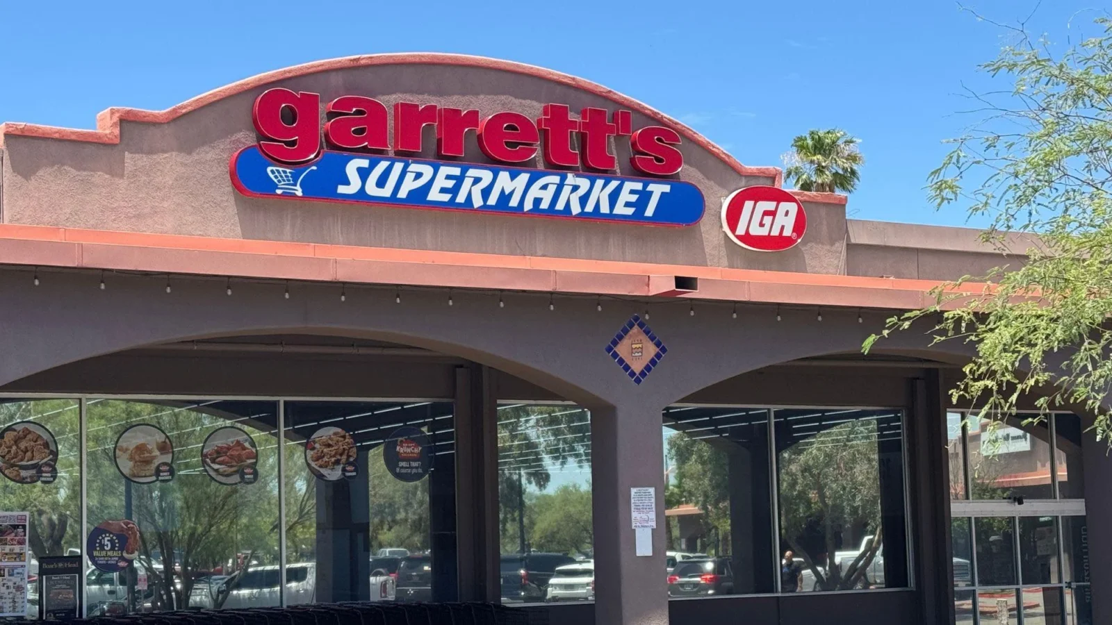 Front of Garrett's IGA Supermarket with the red and blue Garrett's Supermarket sign and IGA logo