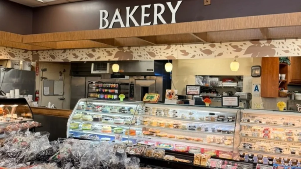 Keil's bakery counter with a Bakery sign and cases of cakes and pastries
