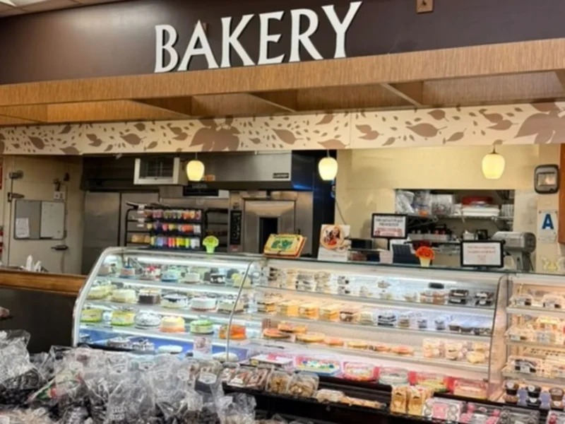 Keil's bakery counter with a Bakery sign and cases of cakes and pastries