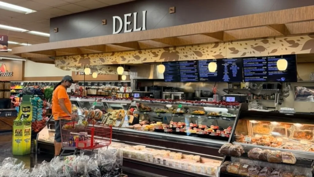 Keil's deli counter with a Deli sign, menu boards and a shopper