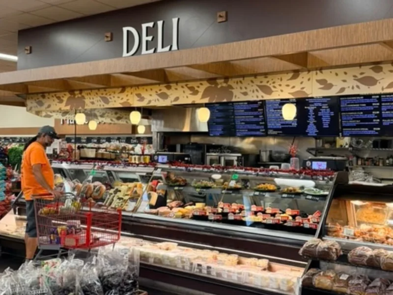 Keil's deli counter with a Deli sign, menu boards and a shopper