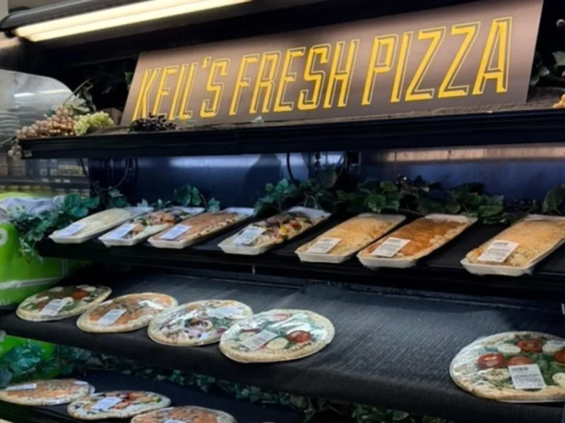 Keil's Fresh Pizza sign above shelves of take-and-bake pizzas