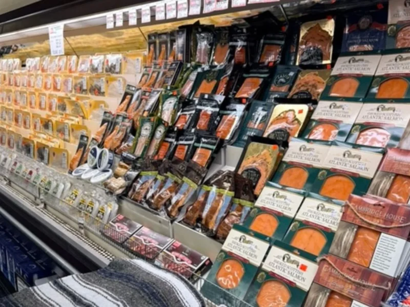Refrigerated case of packaged smoked salmon and lox