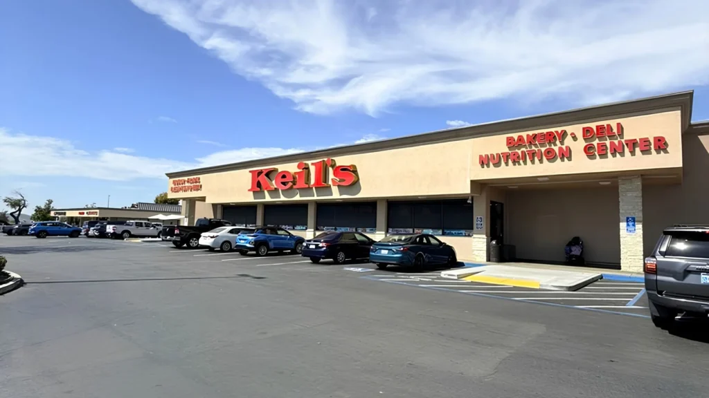Wide view of the Keil's Fresh Food Store building and parking lot under a blue sky