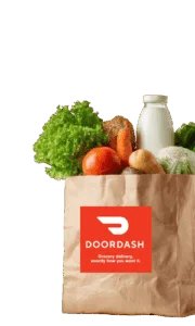 Paper grocery bag of fresh produce, bread and milk with the DoorDash logo