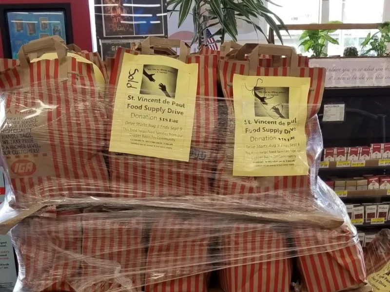 Donation bags for the St. Vincent de Paul Food Supply Drive stacked at Norm's IGA