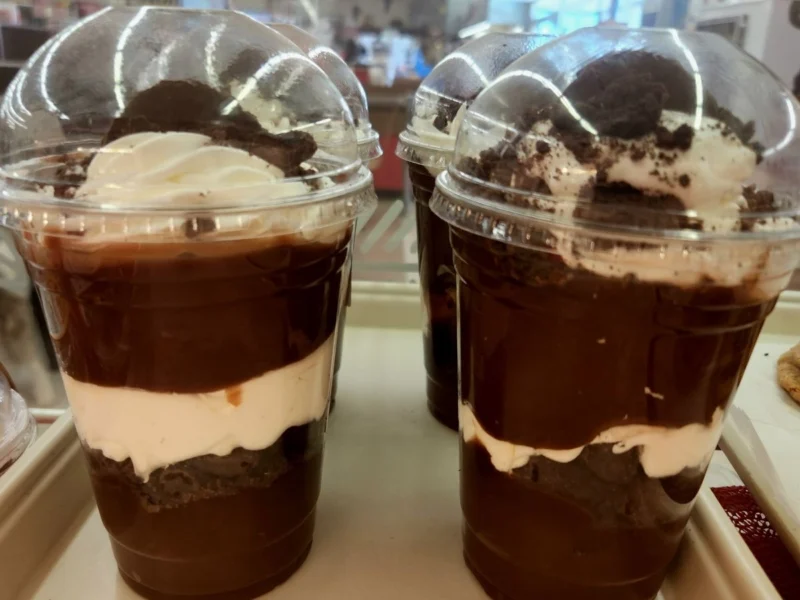 Layered chocolate cream parfait cups in the bakery case
