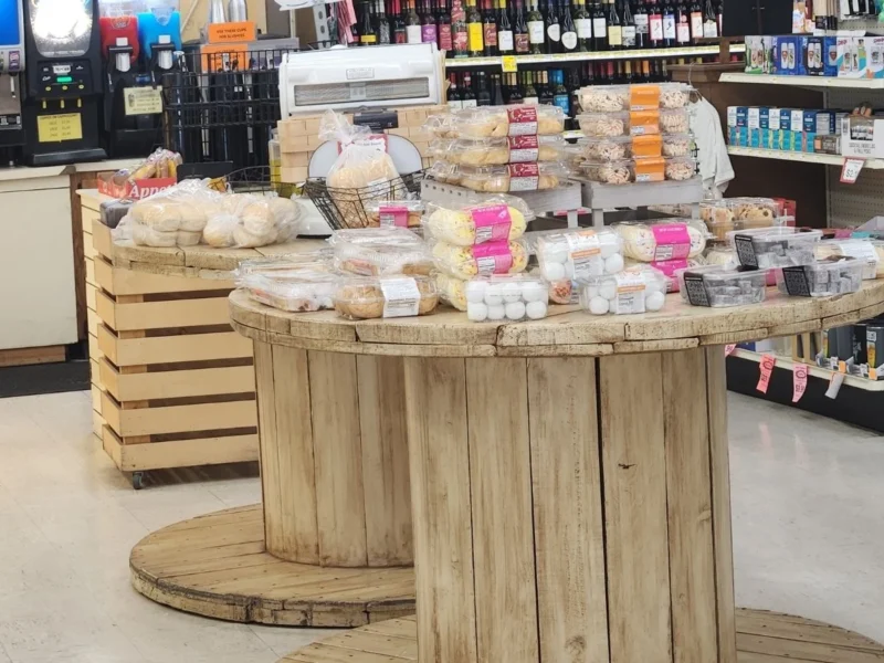 Fresh breads and baked goods displayed on a wooden spool table