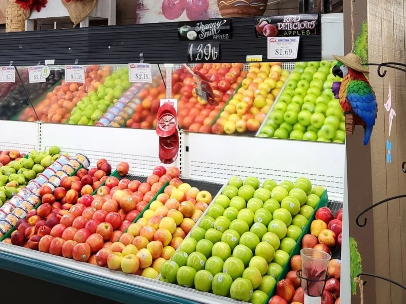 Red and green apples stacked in the produce case