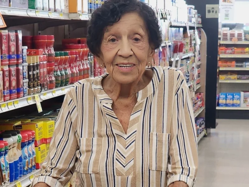 Longtime Kearny shopper smiling in the aisle