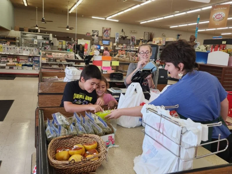 Family checking out at Norm's IGA