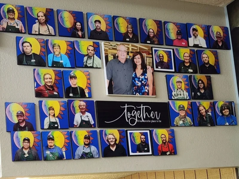 Together portrait wall of the Norm's IGA team with Norm and Myra