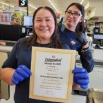 Olsens Marketplace team members holding the IGA Independent Grocers Alliance Five Star award certificate