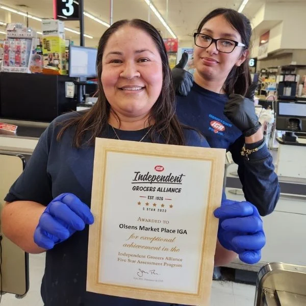 Olsens Marketplace team members holding the IGA Independent Grocers Alliance Five Star award certificate