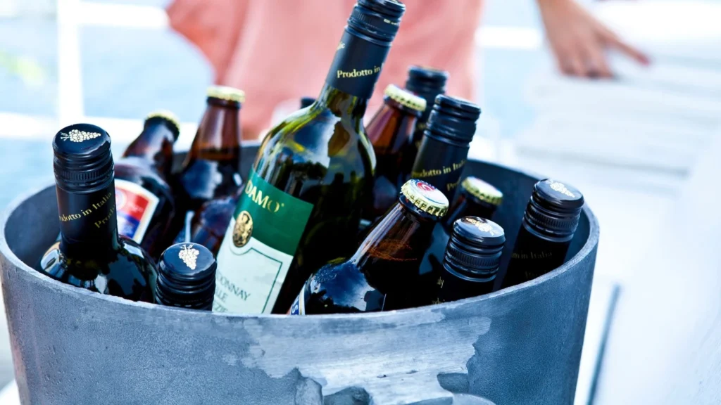 Bottles of wine and beer chilling in an ice bucket